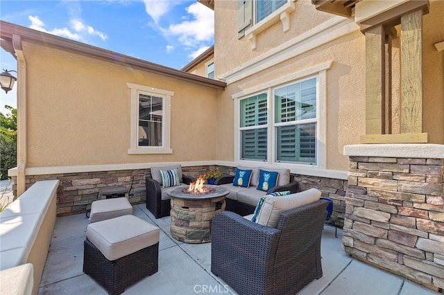 view of patio / terrace featuring an outdoor living space with a fire pit