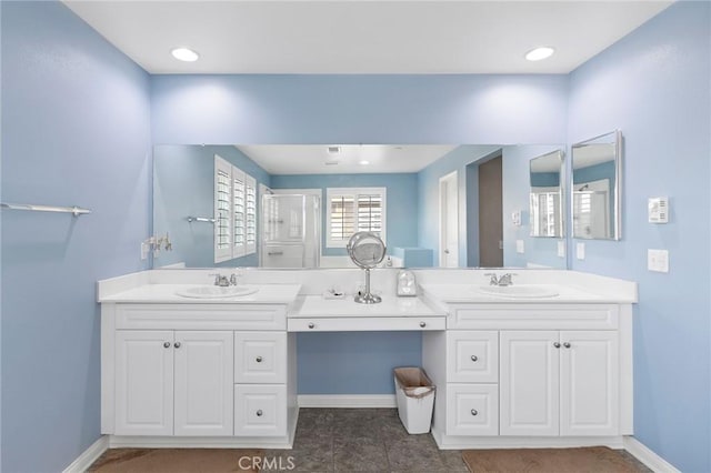 bathroom with a shower with door and vanity