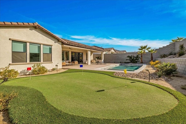 back of house featuring ceiling fan and a patio area