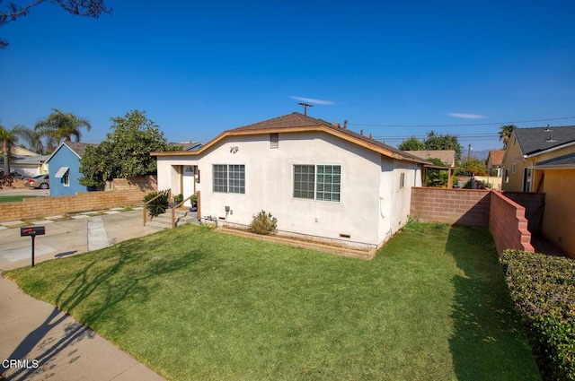 back of house featuring a patio and a yard