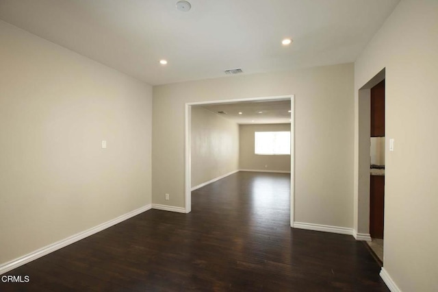 spare room featuring dark hardwood / wood-style flooring