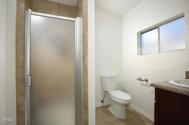 bathroom with vanity, tile patterned floors, toilet, and walk in shower