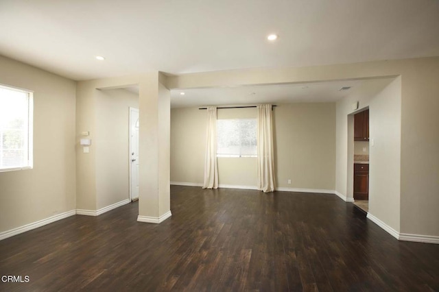 interior space featuring recessed lighting, dark wood finished floors, and baseboards