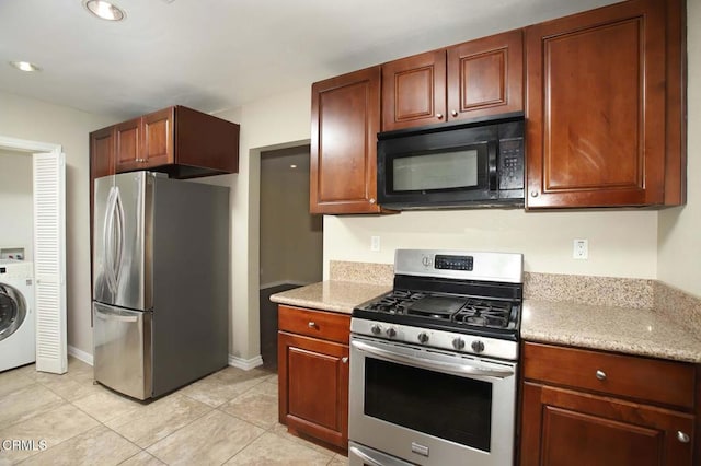 kitchen featuring light tile patterned floors, stainless steel appliances, recessed lighting, washer / dryer, and baseboards