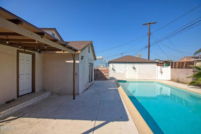 view of swimming pool with a patio, fence, and a fenced in pool