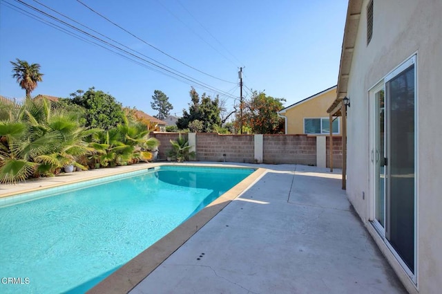 view of swimming pool featuring a fenced backyard, a fenced in pool, and a patio