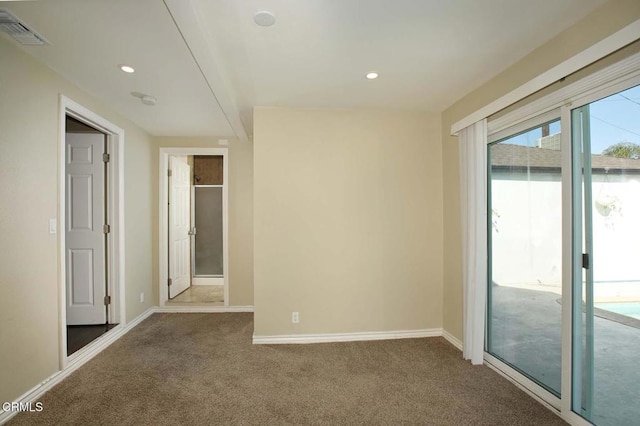 carpeted spare room featuring recessed lighting, visible vents, and baseboards