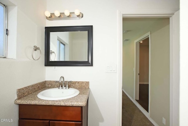 bathroom featuring vanity and baseboards