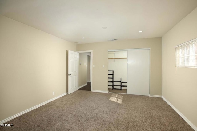 unfurnished bedroom featuring recessed lighting, carpet flooring, visible vents, baseboards, and a closet