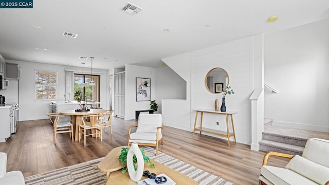 living room with sink and light wood-type flooring