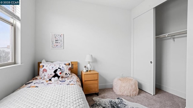 bedroom with carpet flooring and a closet