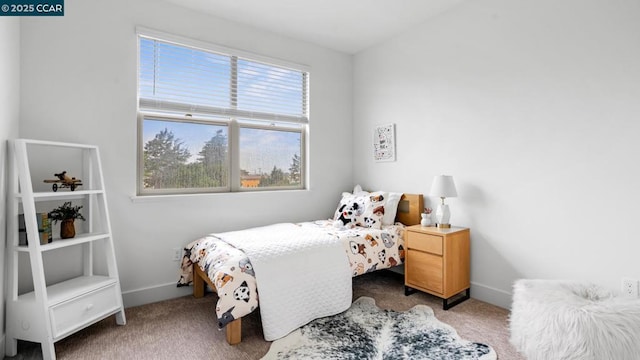 carpeted bedroom featuring multiple windows