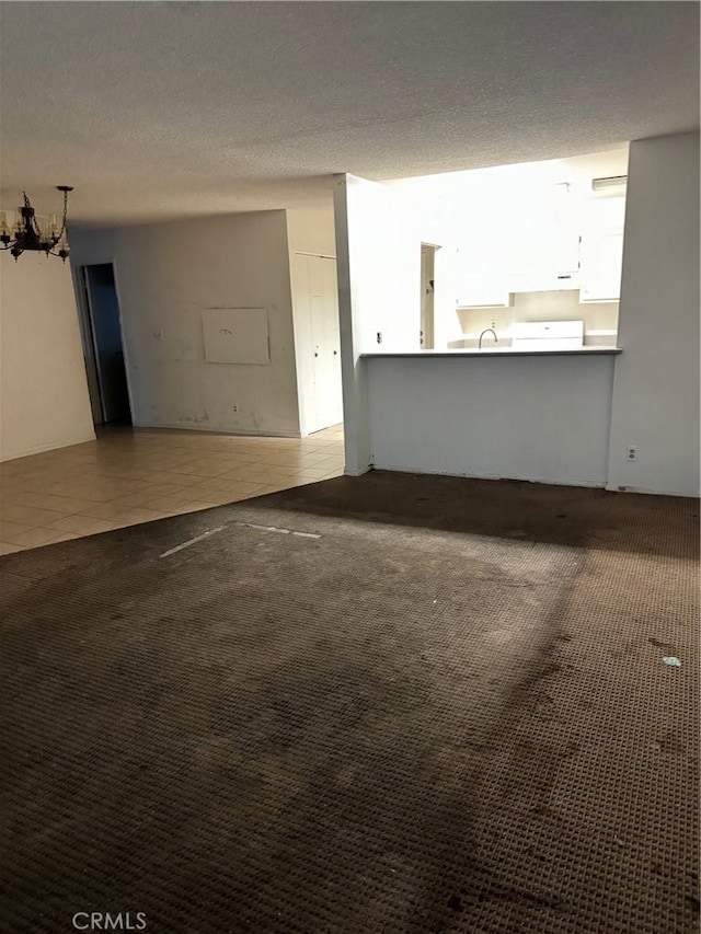 interior space featuring sink, carpet, and a textured ceiling