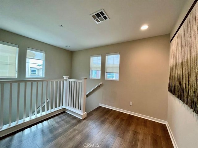 empty room with dark hardwood / wood-style floors