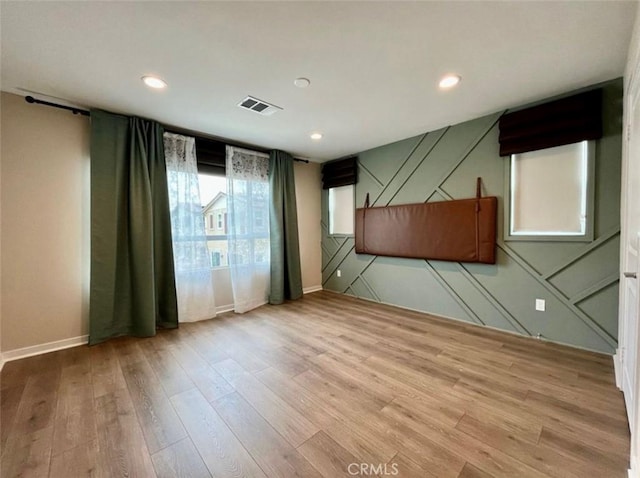 empty room with light hardwood / wood-style floors