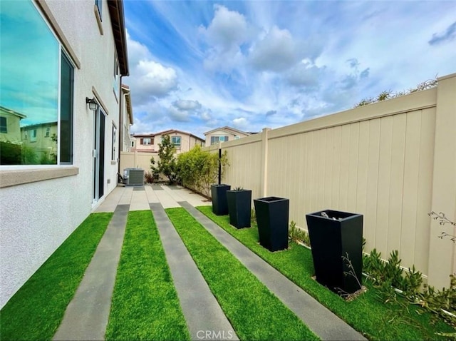 view of yard with central AC unit