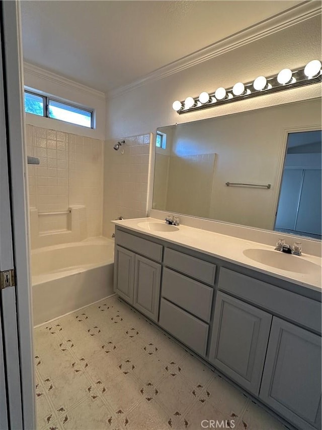 bathroom featuring crown molding, vanity, and washtub / shower combination