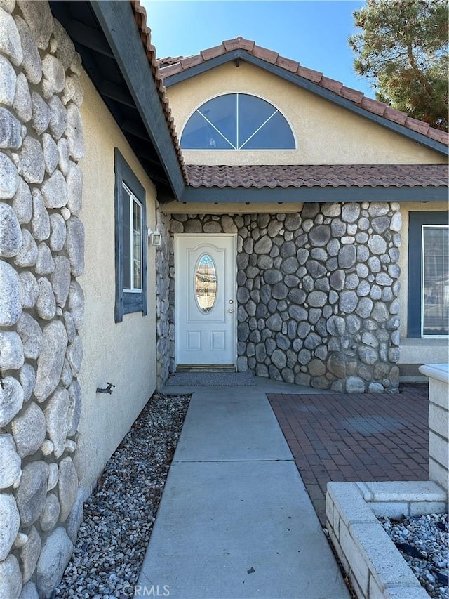 entrance to property with a patio area