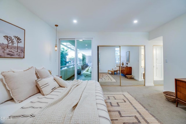 bedroom featuring access to exterior, light colored carpet, and a closet