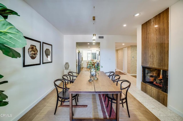 dining space featuring a multi sided fireplace