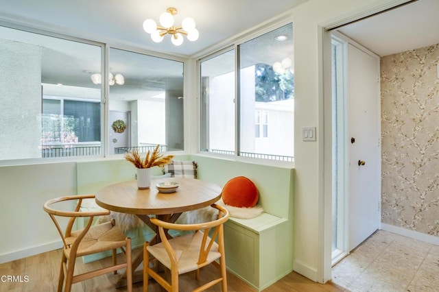 dining space featuring breakfast area and an inviting chandelier