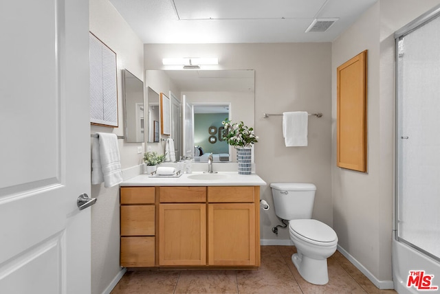 full bathroom featuring vanity, tile patterned floors, enclosed tub / shower combo, and toilet