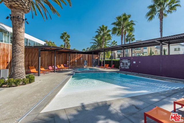 view of swimming pool with a patio area