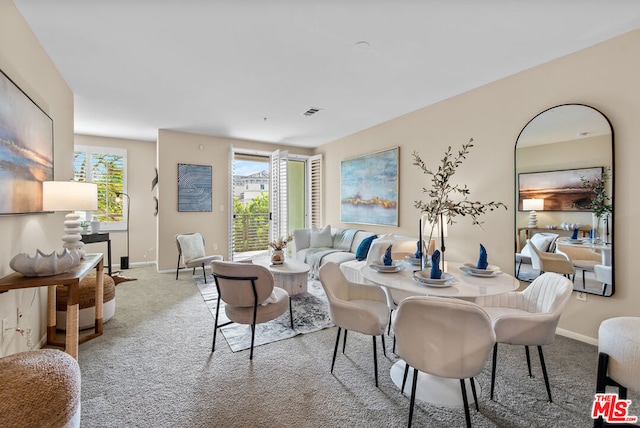 dining room with light colored carpet