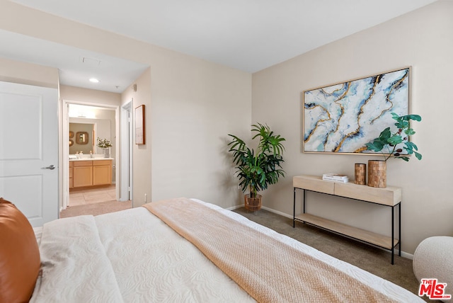 carpeted bedroom featuring ensuite bathroom