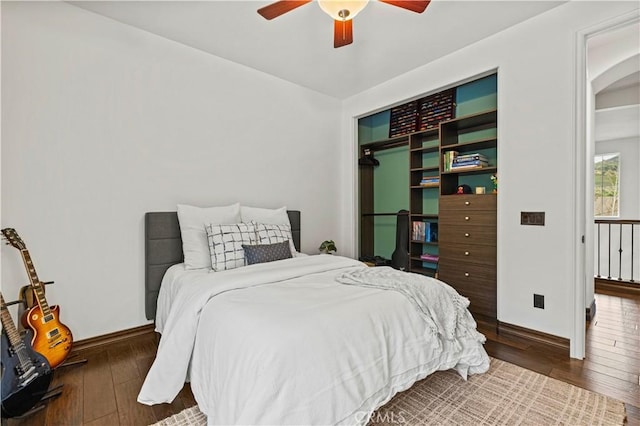 bedroom with dark hardwood / wood-style floors and ceiling fan