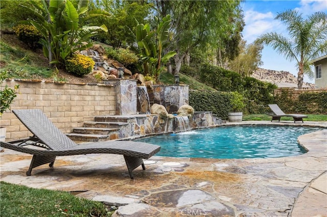 view of pool with pool water feature and a patio area