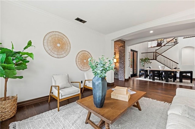 living room with hardwood / wood-style flooring and crown molding