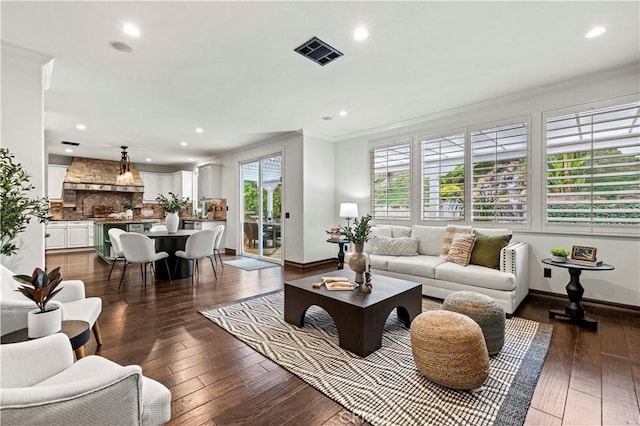 living room featuring a healthy amount of sunlight, ornamental molding, and dark hardwood / wood-style flooring