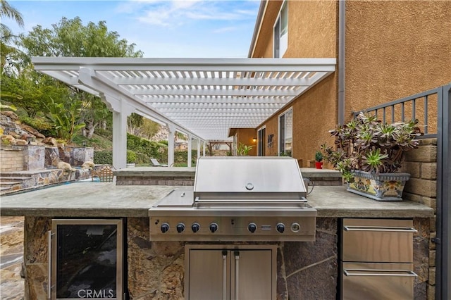 view of patio with exterior kitchen, beverage cooler, and a pergola