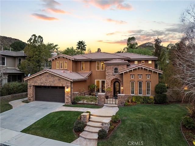 view of front of property featuring a garage and a yard