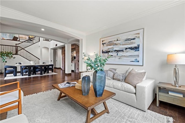 living room with hardwood / wood-style flooring and crown molding