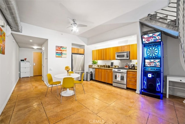 kitchen with ceiling fan, stainless steel appliances, and sink