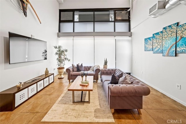 tiled living room with a towering ceiling