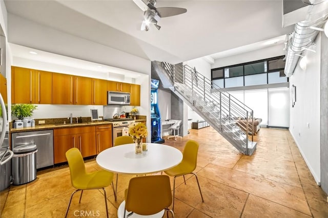 kitchen featuring ceiling fan, appliances with stainless steel finishes, and sink