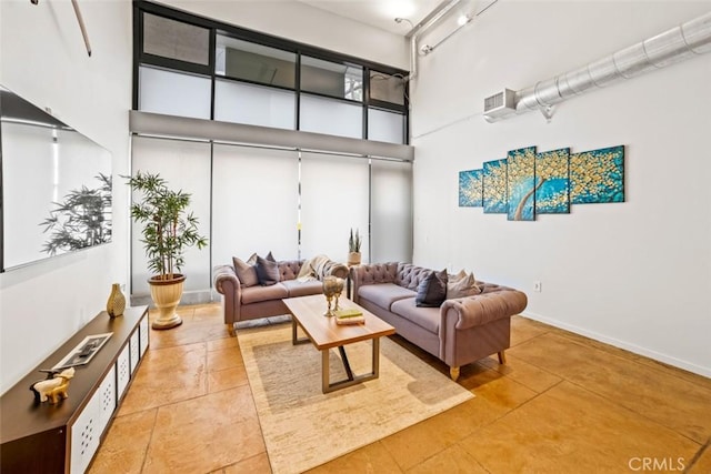 living room featuring a high ceiling and light tile patterned flooring