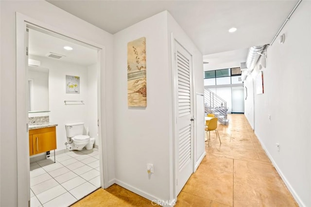 hallway with light tile patterned floors