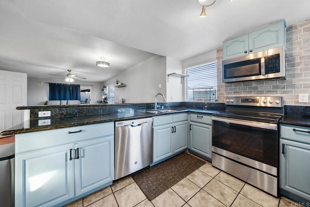 kitchen featuring sink, plenty of natural light, kitchen peninsula, and appliances with stainless steel finishes