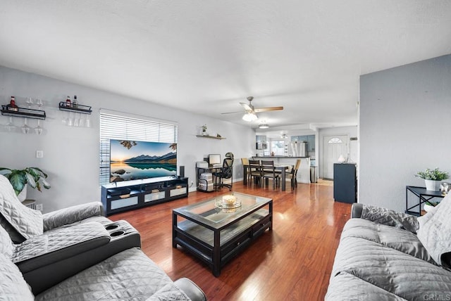 living room with hardwood / wood-style flooring and ceiling fan