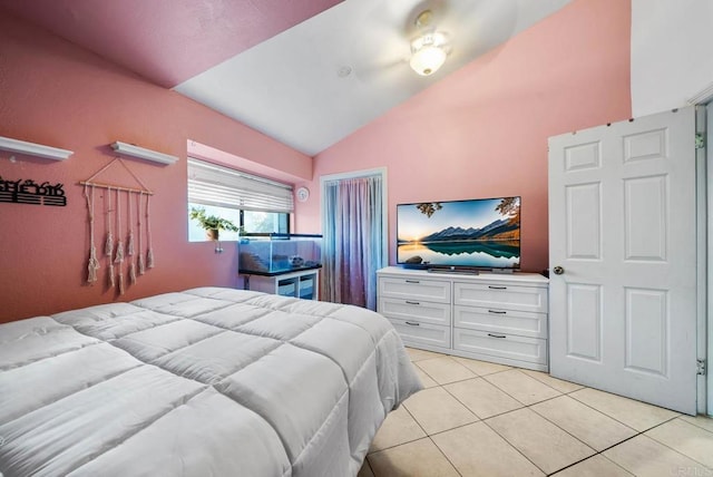 bedroom featuring vaulted ceiling and light tile patterned floors