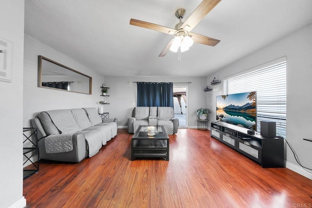 living room featuring hardwood / wood-style flooring and ceiling fan