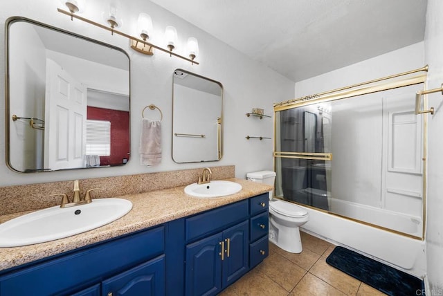 full bathroom featuring tile patterned flooring, vanity, enclosed tub / shower combo, and toilet