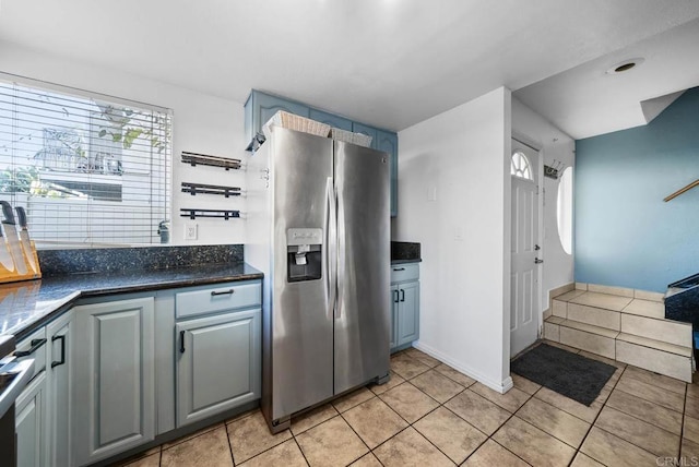 kitchen with gray cabinetry, stainless steel fridge, and light tile patterned floors