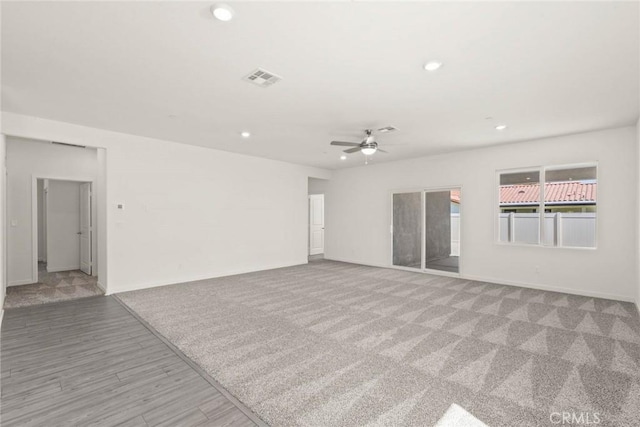 unfurnished living room featuring light wood-type flooring and ceiling fan