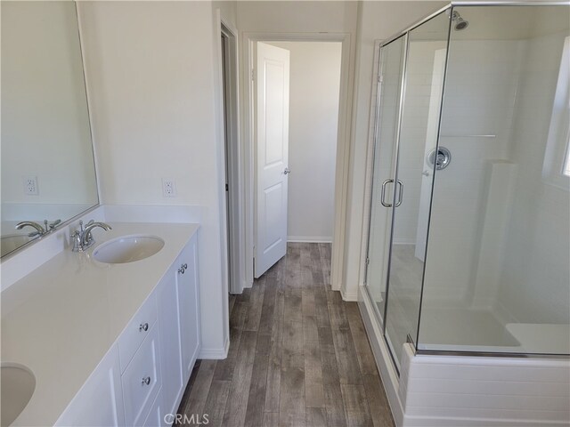 bathroom featuring vanity, hardwood / wood-style floors, and walk in shower