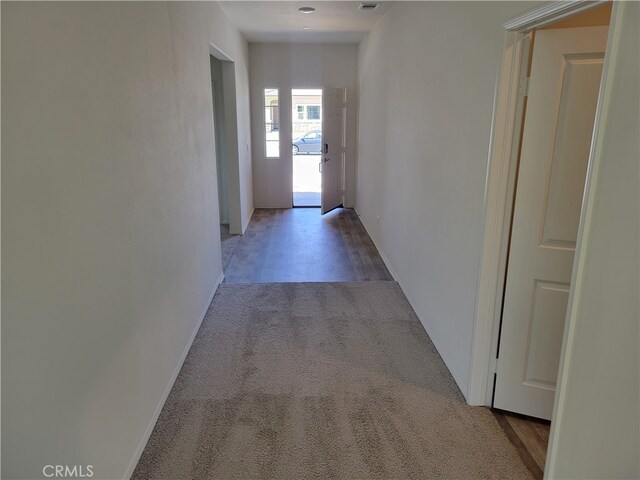 hallway featuring light carpet